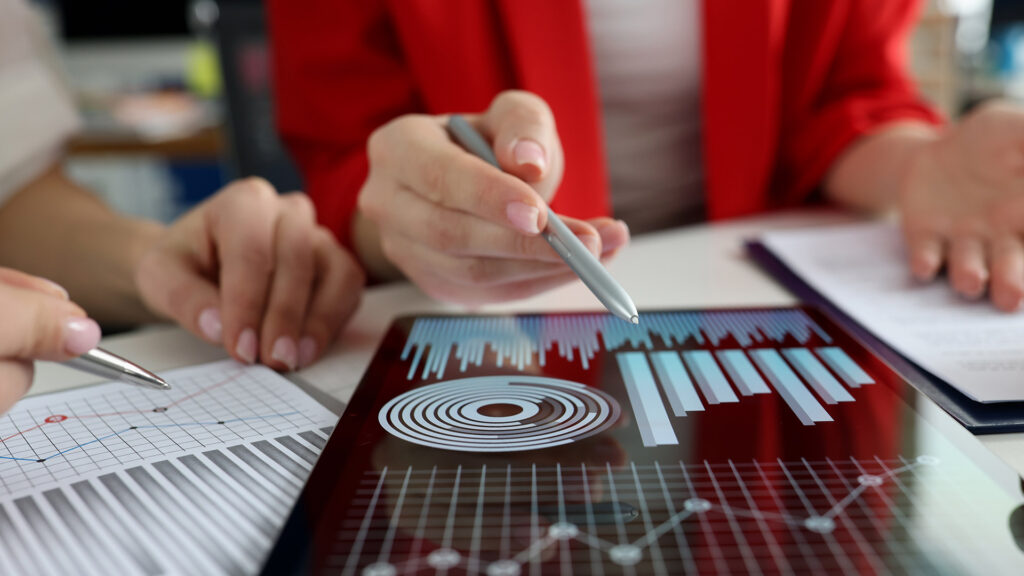 Woman writing Google Analytics stats on iPad